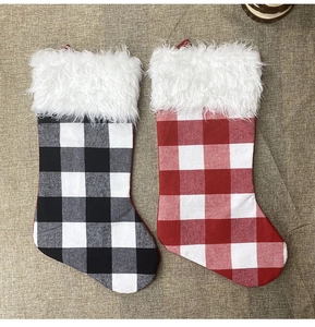 Detail of red and black buffalo plaid Christmas stockings with white faux fur trim