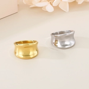Detailed view of irregular 18K gold and silver plated wide band rings in polished finish