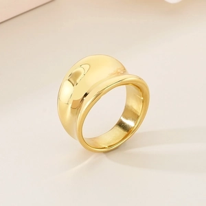 Macro view of wide dome ring in 18K gold finish with high polished mirror surface