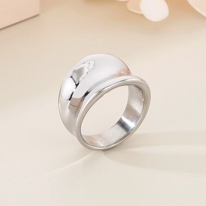 Macro shot of silver chunky dome ring with a polished mirror finish on a cream background