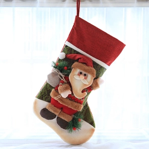 Close-up of a festive Christmas stocking with 3D Santa Claus figure and pine accents