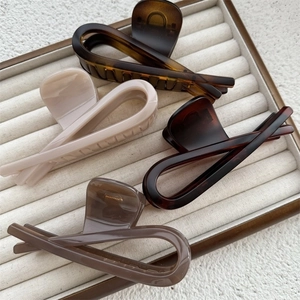 Set of four minimalist acrylic hair claws in amber, beige, dark brown and taupe colors