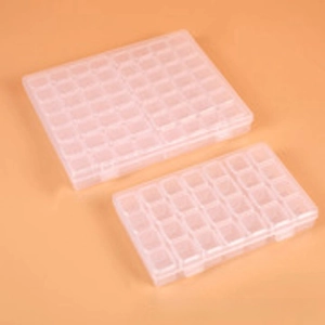 Detail of semi-transparent PP plastic organizer box with multiple compartments for crafts
