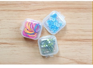 Three clear square plastic boxes showing internal storage of beads and DIY accessories