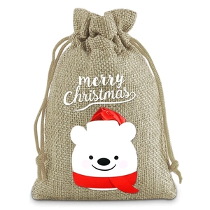 Detail of Christmas burlap gift bag featuring a cute polar bear and merry christmas text