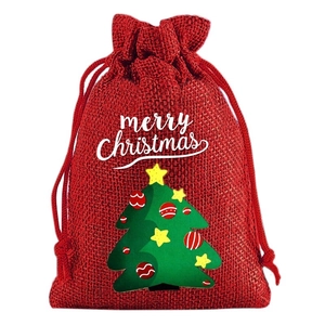 Detail of red burlap Christmas drawstring bag with Merry Christmas text and tree