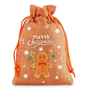 Detail of orange linen Christmas drawstring bag featuring gingerbread man and star prints