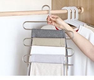 Five-tier S-shaped stainless steel pants hanger showing vertical storage of multiple trousers