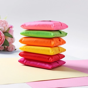 Foldable reusable Oxford cloth shopping bags in multiple bright colors stacked neatly