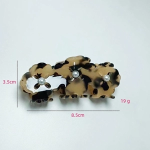 Detail view of tortoiseshell acetate hair claw clip with pearls, 8.5cm length specification