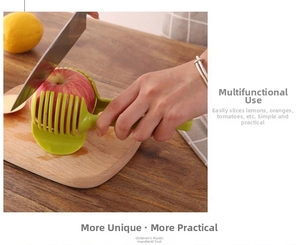 Green plastic handheld fruit slicer holder used for cutting apple slices on a board