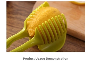 Close-up of green fruit slicer holder guiding a knife to cut even lemon slices on wood