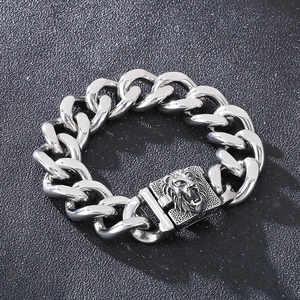 Detailed close-up of a silver stainless steel lion head clasp on a Cuban link chain bracelet