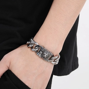 Close-up of hip hop lion head Cuban link bracelet with white diamonds on male wrist