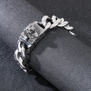 Close-up of silver Cuban chain bracelet featuring a detailed lion head clasp for men