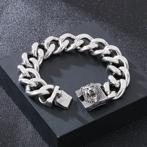 Detailed view of silver lion head buckle on a chunky stainless steel Cuban chain bracelet