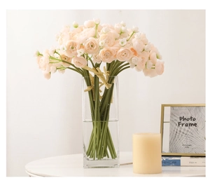 Faux tea rose bouquet in clear glass vase tied with twine for home floral decoration