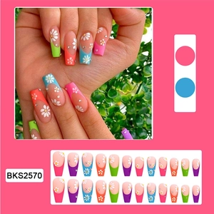 Macro detail of French floral press-on nails with rhinestones and 24-piece full set display