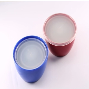 Close-up of blue and red round plastic food bowls with transparent lids on a white background