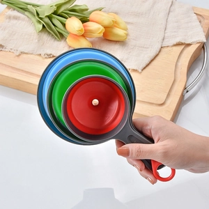 Three-piece set of collapsible silicone funnels in blue green and red with handles