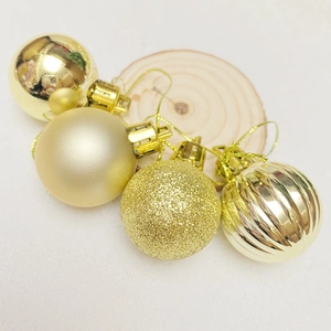 Set of 4 gold Christmas ball ornaments with glossy, matte, glitter, and pumpkin textures