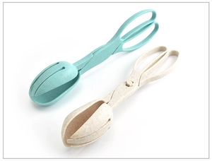 Close-up of wheat straw tongs in blue and beige for salad, bread, and outdoor grilling