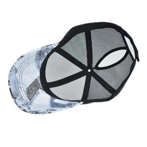 Detail showing vintage blue tie-dye pattern brim and black mesh back of trucker hat