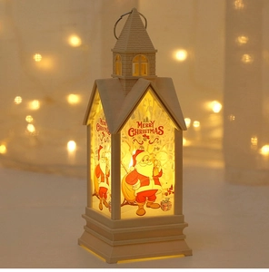 Detail of Christmas lantern with warm LED light, Merry Christmas graphic and handle
