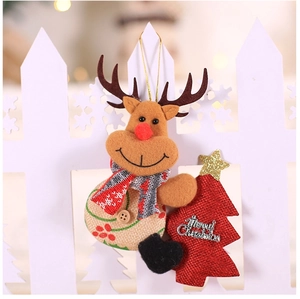 Detail of fabric reindeer ornament with Merry Christmas tree and knitted scarf
