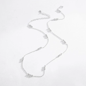 Detailed top view of a delicate S925 sterling silver beaded necklace on white background