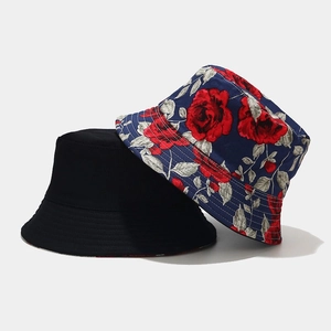 Dual-sided bucket hat featuring solid black and red rose floral print on navy blue canvas