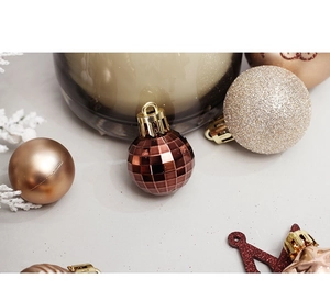 Detailed view of champagne and rose gold Christmas ornaments with various textures