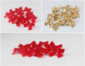 Detailed view of red flocked and metallic gold mini Christmas decorative bows in bulk