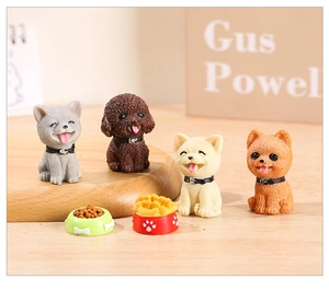 Close-up of resin miniature puppy figurines including Husky and Teddy for garden decor