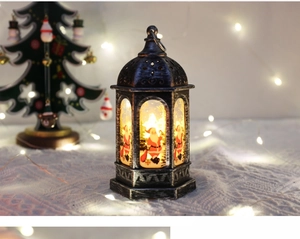 Detail view of retro Christmas lantern featuring Santa Claus pattern and warm LED glow