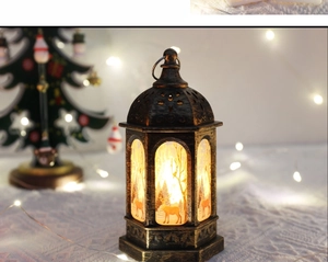 Detailed view of bronze Christmas lantern with elk silhouette and warm glowing light effect