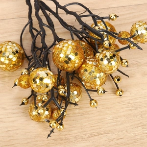 Artificial Christmas berry picks with gold glitter finish on dark branch for tree decor