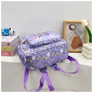 Detail of purple unicorn backpack with rainbow patterns and front zipper pocket