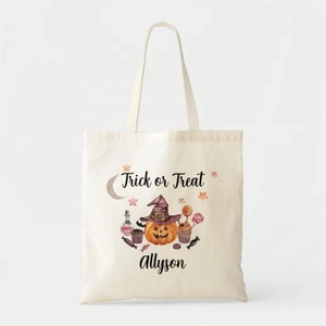 Detailed view of canvas tote bag featuring Halloween pumpkin print and festive text
