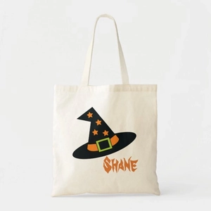 Detail of white canvas tote bag featuring wizard hat print and custom SHANE lettering