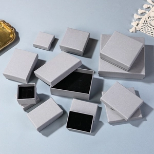 Elegant grey textured jewelry gift boxes with black velvet lining for rings and watches