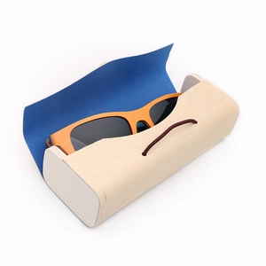 Wooden sunglasses with yellow frames and matching wood grain storage case on white background