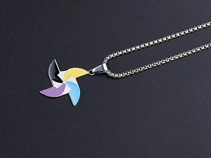Detailed macro view of colorful windmill pendant on a silver box chain necklace