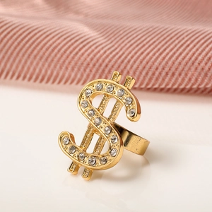 Close-up of hip hop gold dollar sign ring with sparkling crystals and polished finish