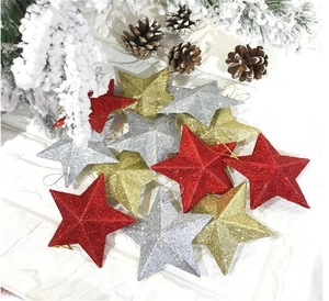 Detail of glittery gold, red and silver star ornaments for Christmas tree decoration