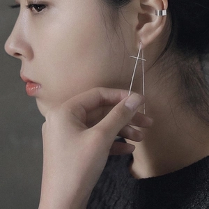 Minimalist S925 sterling silver cross earring with long chain and ear cuff on a model