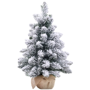 Close-up of mini Christmas tree with artificial snow and rustic burlap base cover