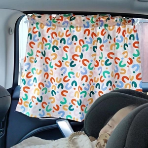 Detailed car sunshade for babies featuring colorful geometric patterns on a side window