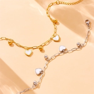 Gold and silver heart pendant bracelets with white shell inlay and beaded chain detail