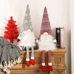 Red and grey Christmas gnome figurines set on a cozy mantelpiece for holiday decor